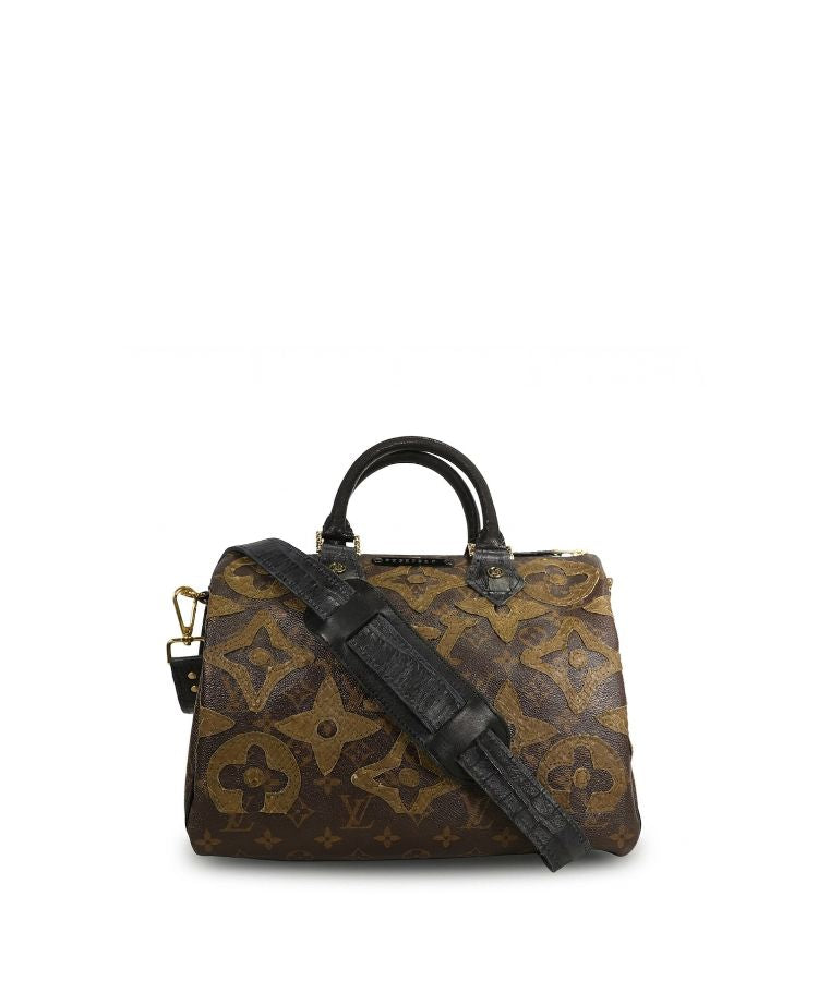 Brown patterned handbag with a black strap on a white background