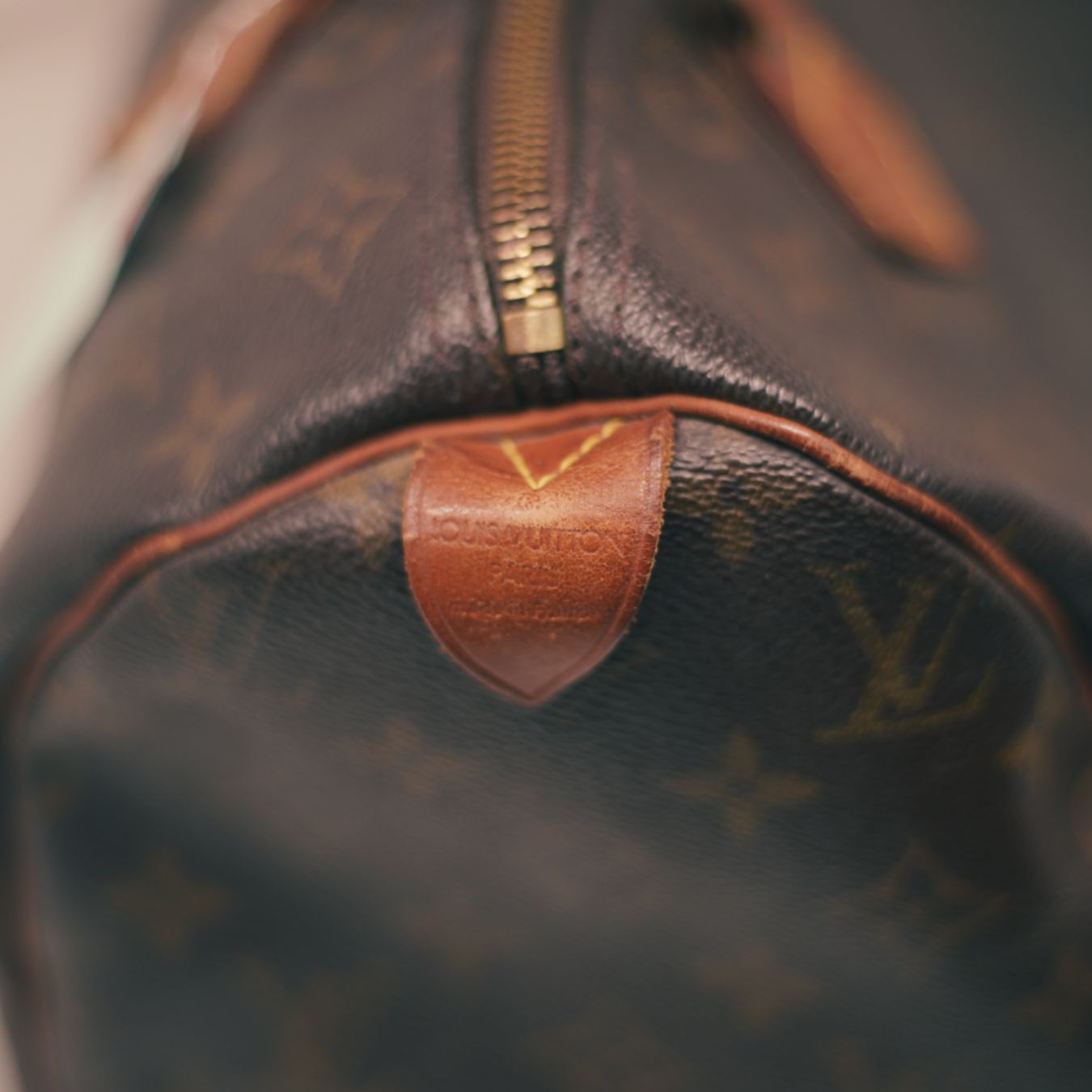 Close-up of a vintage Louis Vuitton bag with monogram pattern.