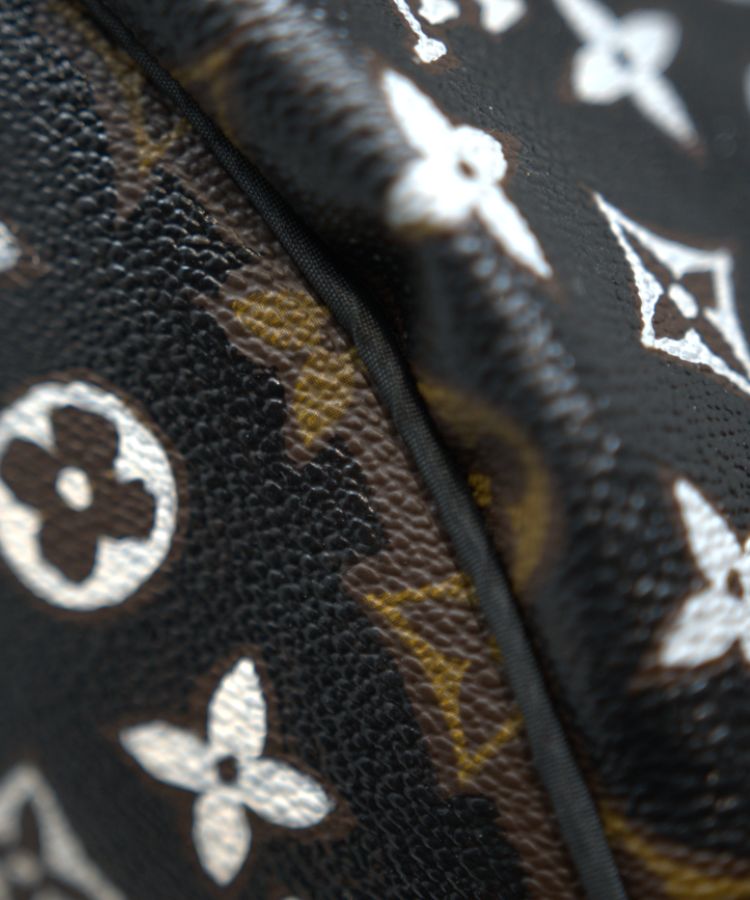 Close up of a Philip Karto patterned surface handbag with Louis Vuitton monogram design in black and white and the original canvas color.
