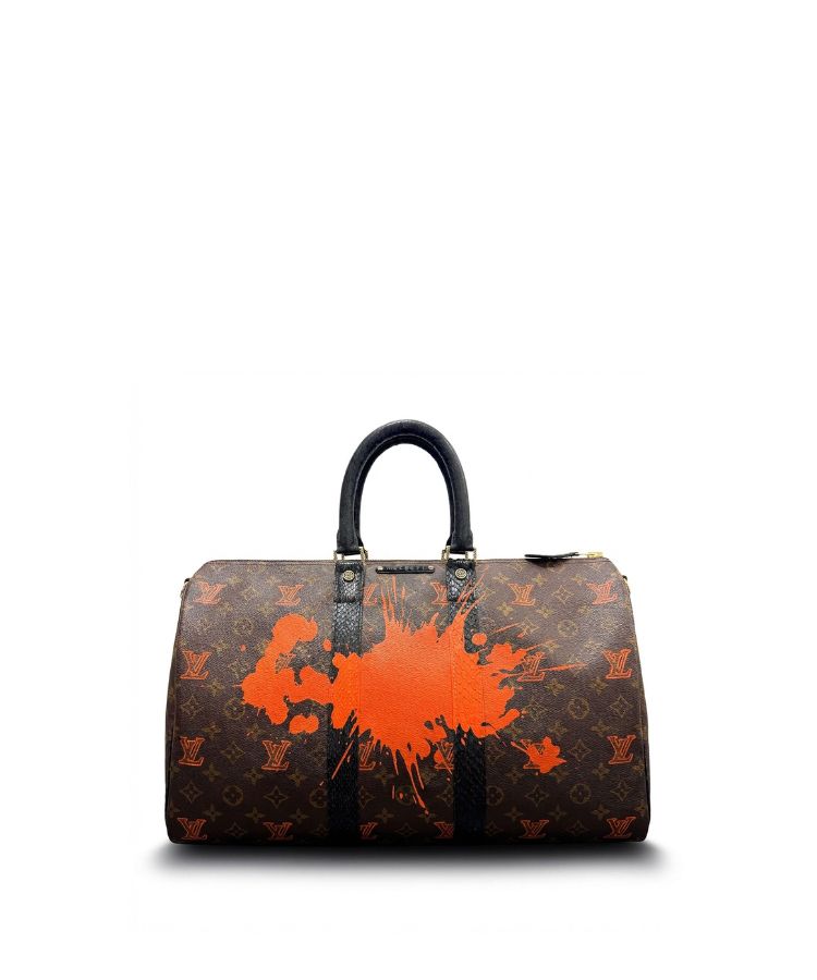 Philip Karto vintage Louis Vuitton handbag with orange paint splatter on a white background