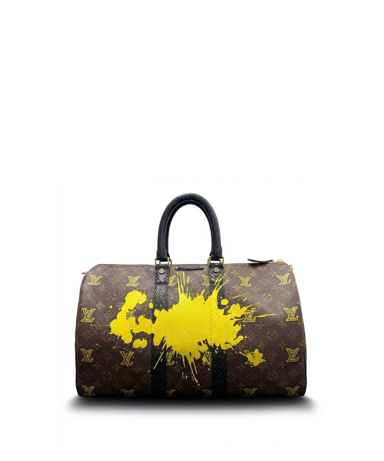 Philip Karto vintage Louis Vuitton handbag with yellow paint splashes and monogram on a white background