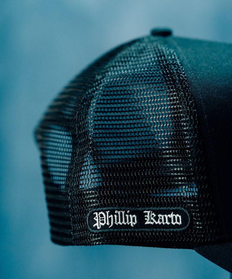 Black PK Cap mesh cap with 'Phillip Karto' logo on a blue background