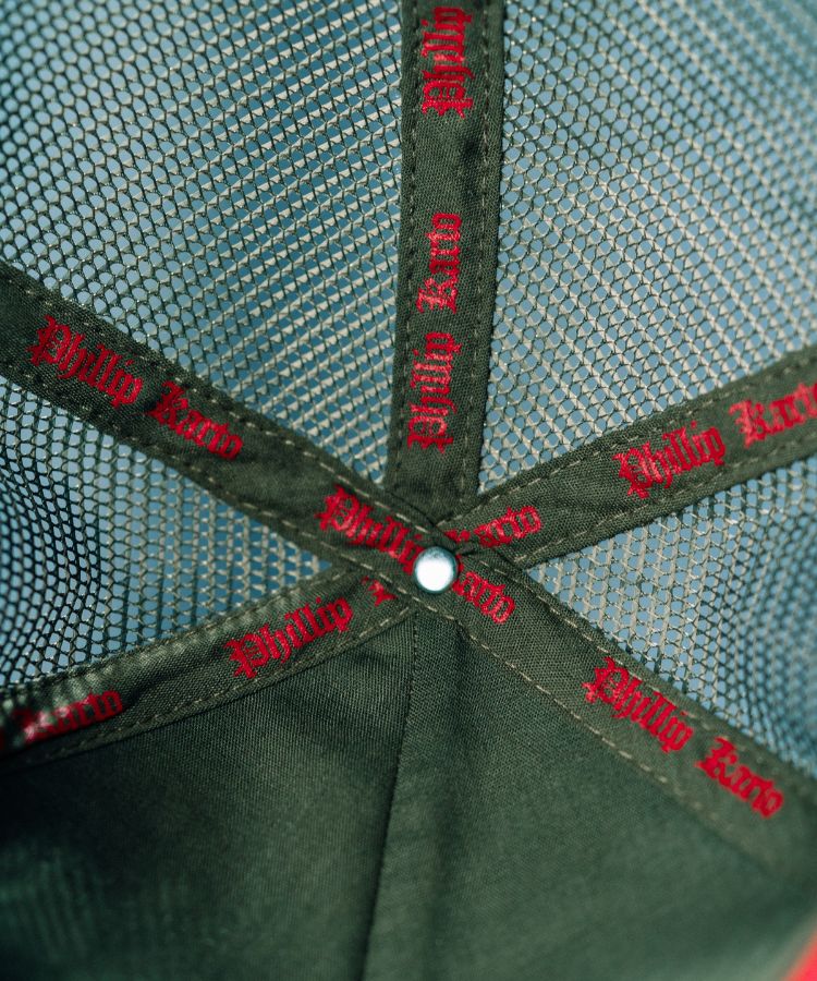 Close-up of Camouflage PK Cap "Not For Everyone" Model by Philip Karto branding on the mesh and visor.