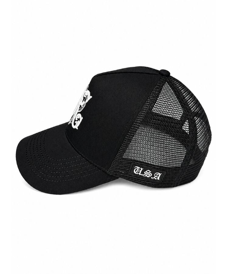 A black trucker-style baseball cap with a curved brim, black mesh back panels, a white skull and crossbones graphic on the front, and 'USA' embroidered in white on the side, shown against a plain white background from Phjilip Karto Not For Everyone collection.