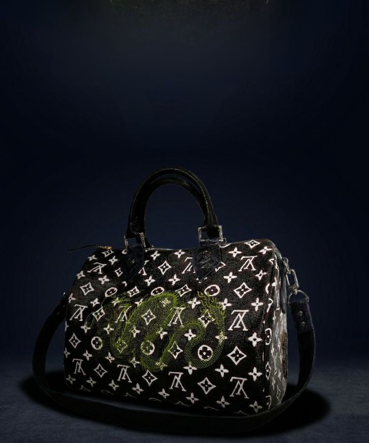 Designer handbag with monogram pattern on a dark background