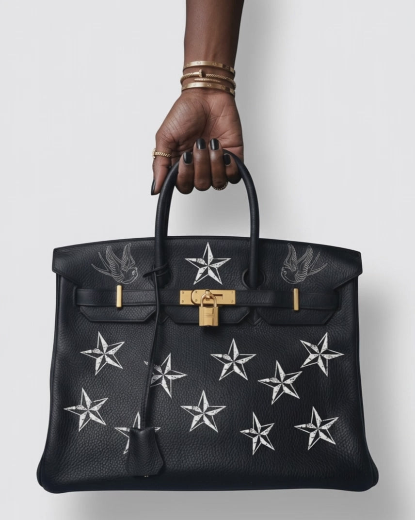 Vintage Hermes Birkin handbag in black transformed into a Philip Karto I'm Not A Star model. The video shows a hand holding the Birkin and turning it to see both sides with different designs and a white background